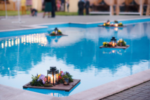 The glowing candles on the pool